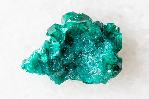 Preview: sample of raw dioptase mineral on white marble