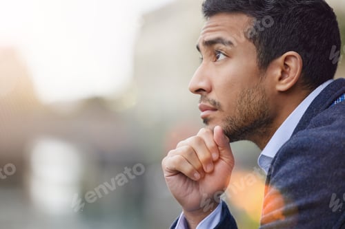 Preview: Life seems to speed by. Shot of a handsome young businessman day dreaming.