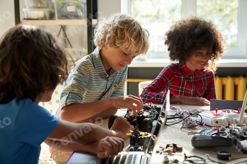 Preview: Diverse schoolkids building robotic technologies at STEM educational class.