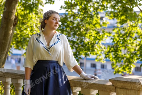 Preview: A girl stands with a suitcase in her hands on the embankment of the river station, port.