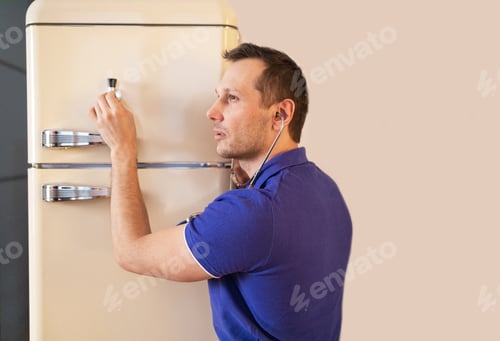 Preview: Repairman contractor repairing fridge in DIY concept