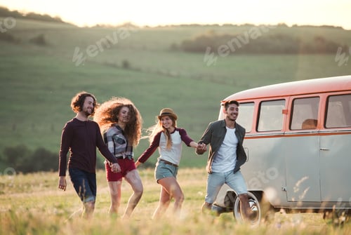 Preview: A group of young friends on a roadtrip through countryside, running.