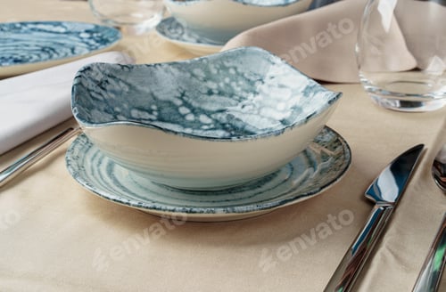 Preview: Details of a stylish table setting with textured ceramic dishes