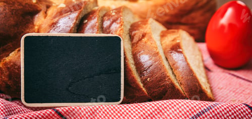Preview: Easter traditional bread and eggs on wooden background