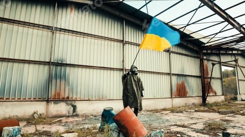Preview: Ukrainian flag carried on the shoulder in the middle of the rubble