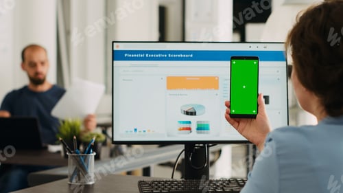 Preview: Adult holding phone with greenscreen