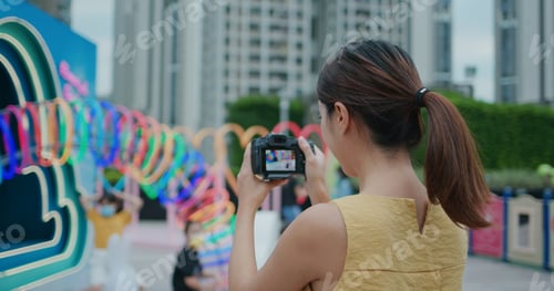 Preview: Woman use digital camera to take photo at outdoor