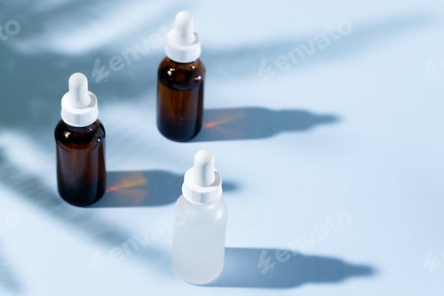Preview: Glass jar with skincare liquid on gray background with shadow