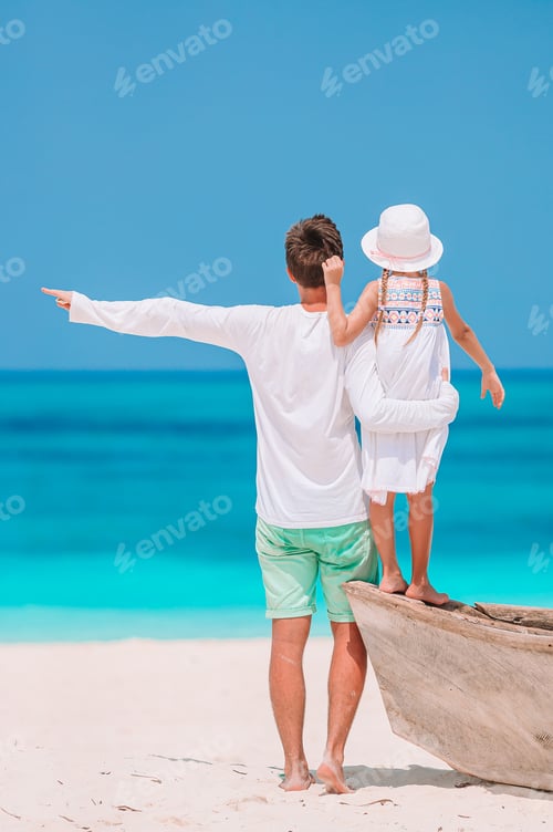 Preview: Little girl and happy dad having fun during beach vacation