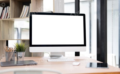 Preview: A modern office desktop with a white, blank computer screen.