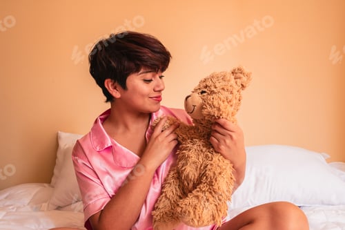 Preview: Young woman holding soft teddy bear