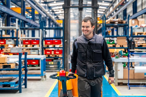 Preview: Man carrying a chart in a corridor of a logistic factory