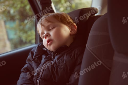 Preview: Male toddler asleep in car backseat
