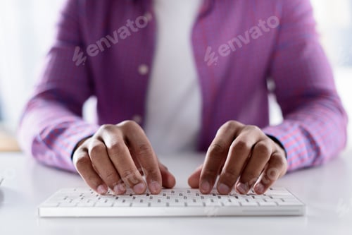 Preview: cropped image of african american man typing at keyboard