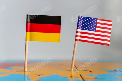 Preview: Small flags of Germany and the USA on a wooden stick fixed on the globe