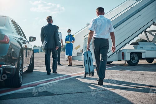 Preview: Jet staff meeting businessman with assistant on runway