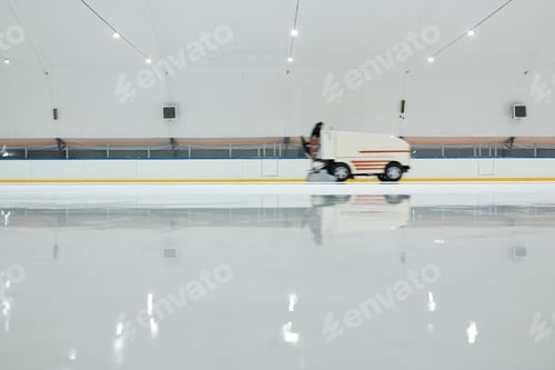 Preview: White truck or ice flattening machine moving along ice-rink at sports center