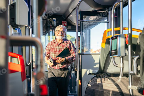 Preview: Senior man smiling riding public city bus