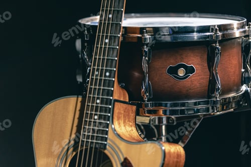Preview: Acoustic guitar and snare drum on a black background isolated.