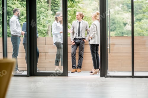 Preview: Business people on the office balcony during a break