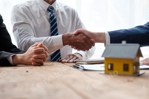 Preview: Residential house businessman banker shake hand with customer after successful agreement and signing