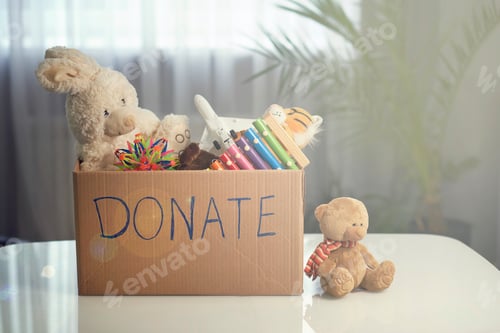 Preview: Donation box with children toys. woman collects toys for charity.
