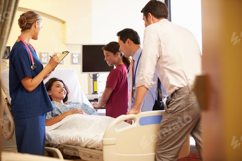 Preview: Medical Team Meeting Around Female Patient In Hospital Room