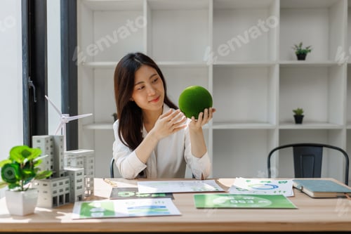Preview: Woman holding green sphere promoting sustainable future
