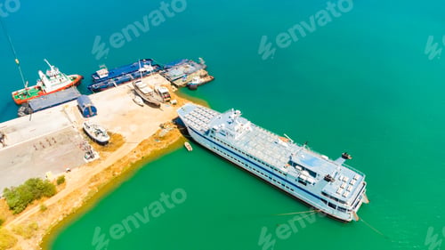 Preview: Ferry in the sea port. on the background cranes and containers