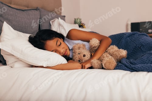 Preview: Girl sleeping at day. Little girl lying on a bed with teddy toy.