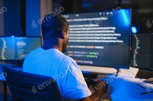Preview: Portrait of african american male programmer in office at night