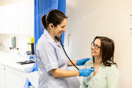 Preview: Nurse checking patient with stethoscope