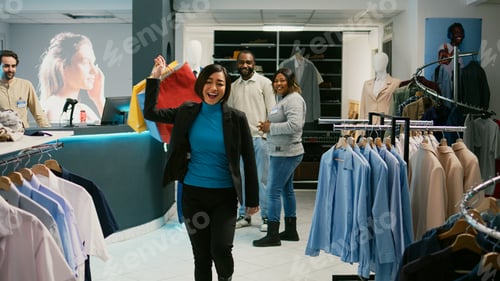 Preview: Asian customer doing dance moves with shopping bags