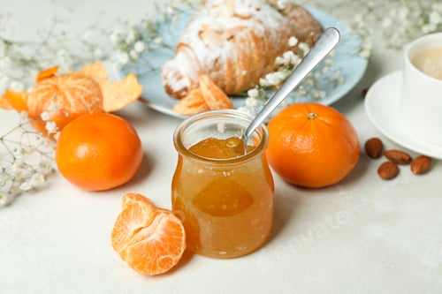 Preview: Concept of tasty breakfast with mandarin jam on white textured table