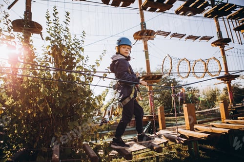 Preview: a 6-year-old boy is engaged in rock climbing on a training track. active sport
