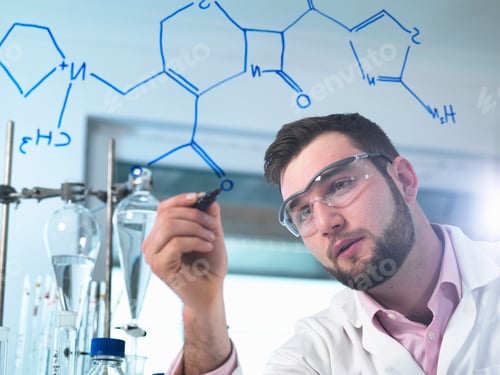 Preview: Scientist illustrating antibiotic chemical formula in laboratory for pharmaceutical research