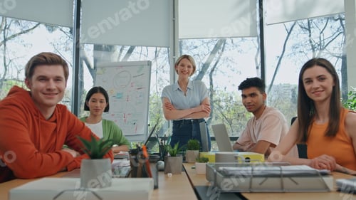 Preview: Smiling startupers looking camera modern cabinet. Five people sitting together