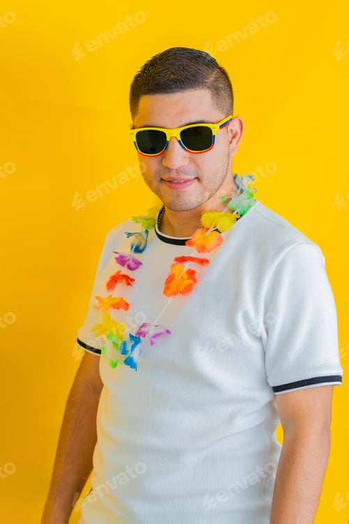 Preview: latin man with defiant and happy pose looking straight ahead with sunglasses and a flower necklace