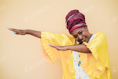 Preview: Senior african woman dancing outdoor - Focus on face