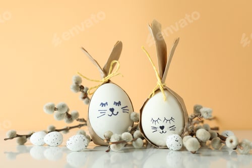 Preview: Easter bunnies made of eggs, quail eggs and catkins against beige background