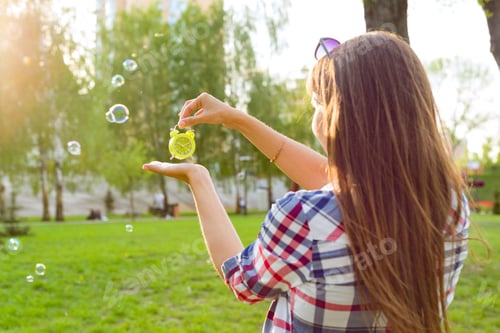 Preview: Woman Holding Clock Outdoors with Bubbles Around Her