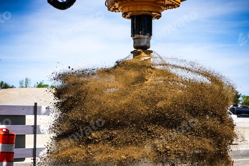 Preview: Closeup shot of an excavator with drill attachment spinning off dirt