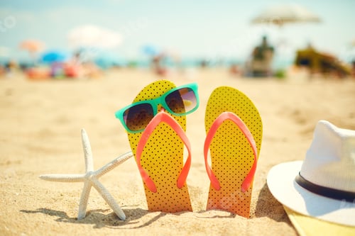 Preview: Starfish near flip flops and sunglasses on beach