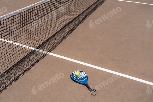 Preview: Padel racket and balls on court