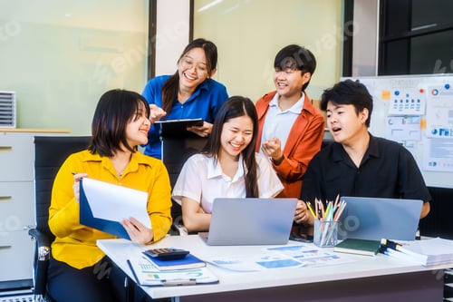 Preview: Five young Asian professionals collaborate at a startup meeting, analyzing finances, strategy