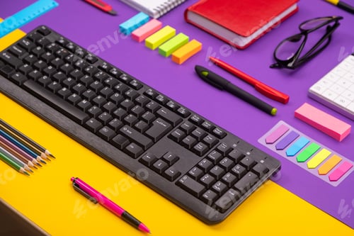 Preview: Modern working place with keyboard, diary, pencils, pens and glasses on orange-purple background