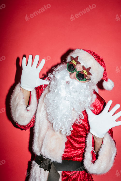 Preview: Man dressed as Santa Claus gesturing with funny glasses