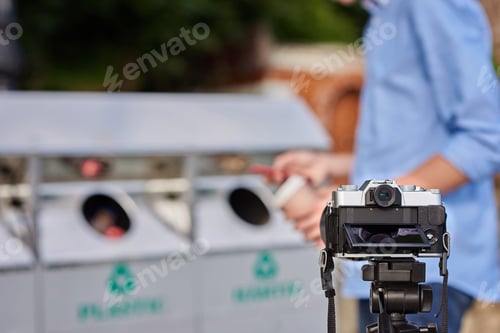 Preview: Man throwing paper coffee cup in waste sorting bin of the park