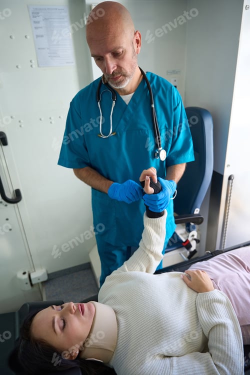 Preview: Woman with neck brace lies on gurney at medical procedure
