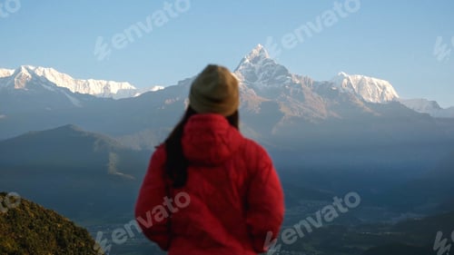 Preview: Woman traveler looking at Machapuchare peak, Annapurna mountain range in Pokhara , Nepal